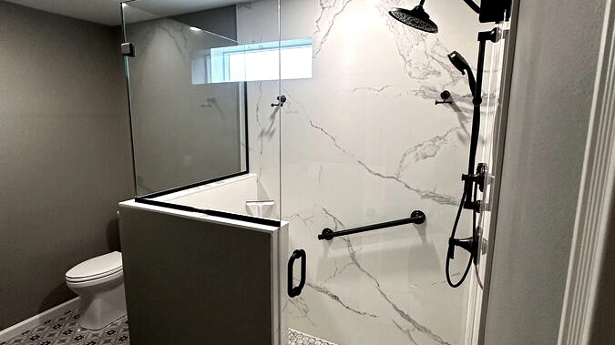 Full bathroom, Walk-in shower · patterned tile floor by DA Interior Solutions