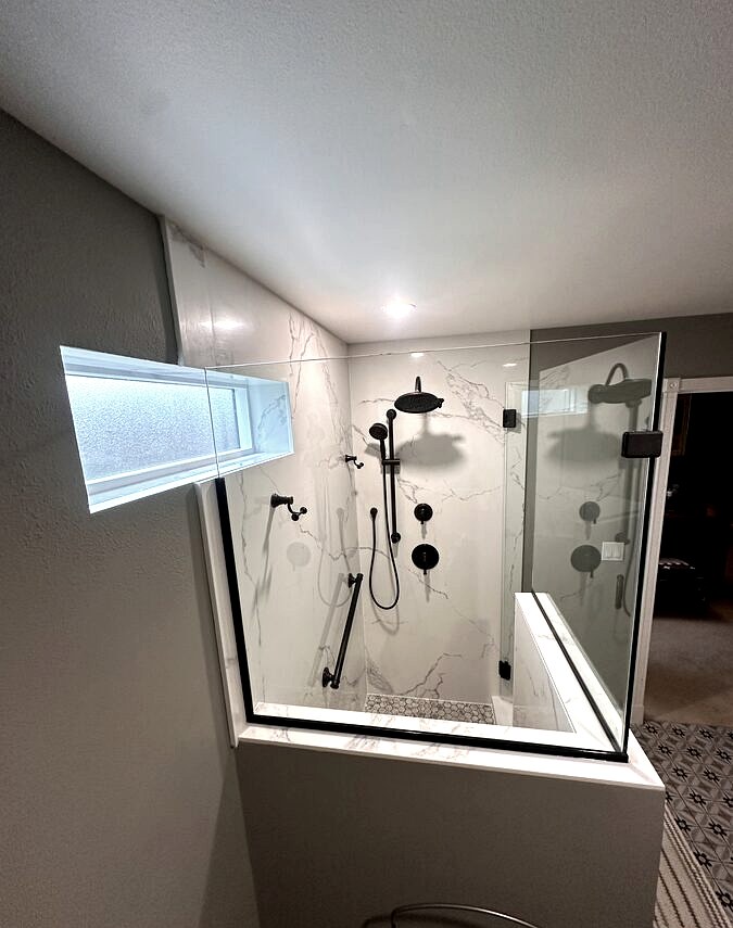 Walk-in shower with frameless glass, hex mosaic field and linear drain