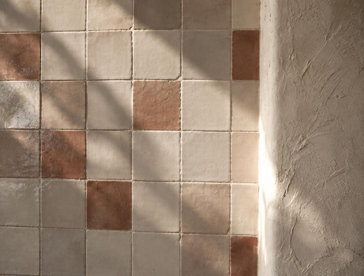 Material study, hand-set matte tile field beside lime plaster