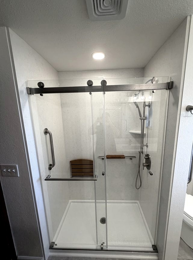 Sliding-glass shower, Low-profile slider · niche storage by DA Interior Solutions